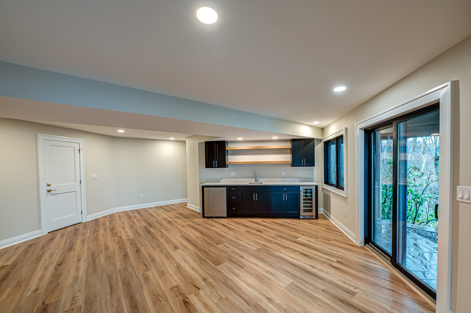 Finished basement with modern bar setup in a Miller Place custom home by Long Island Creative Contracting