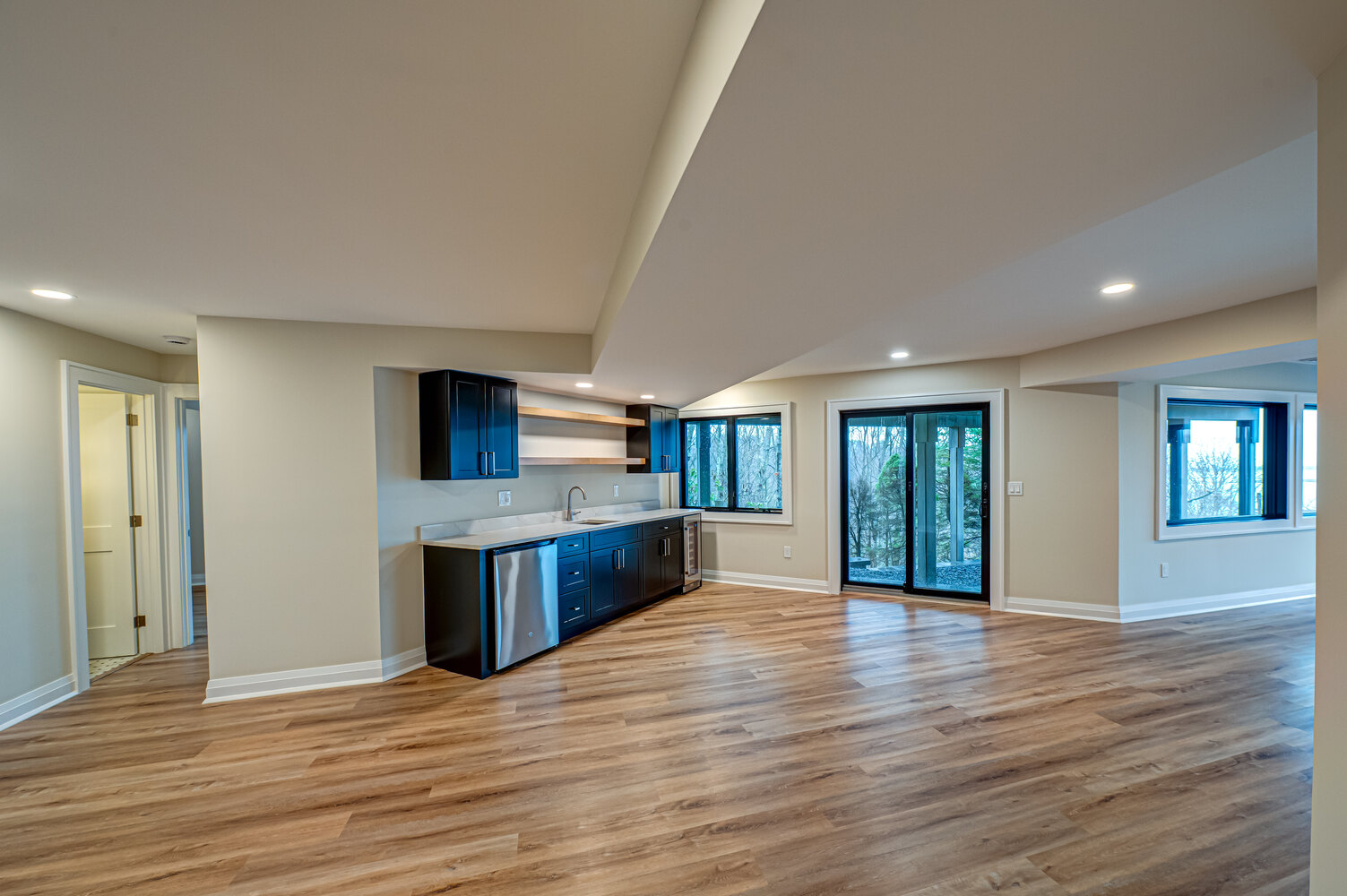 Finished lower level with wet bar and modern flooring in a Miller Place home by Long Island Creative Contracting