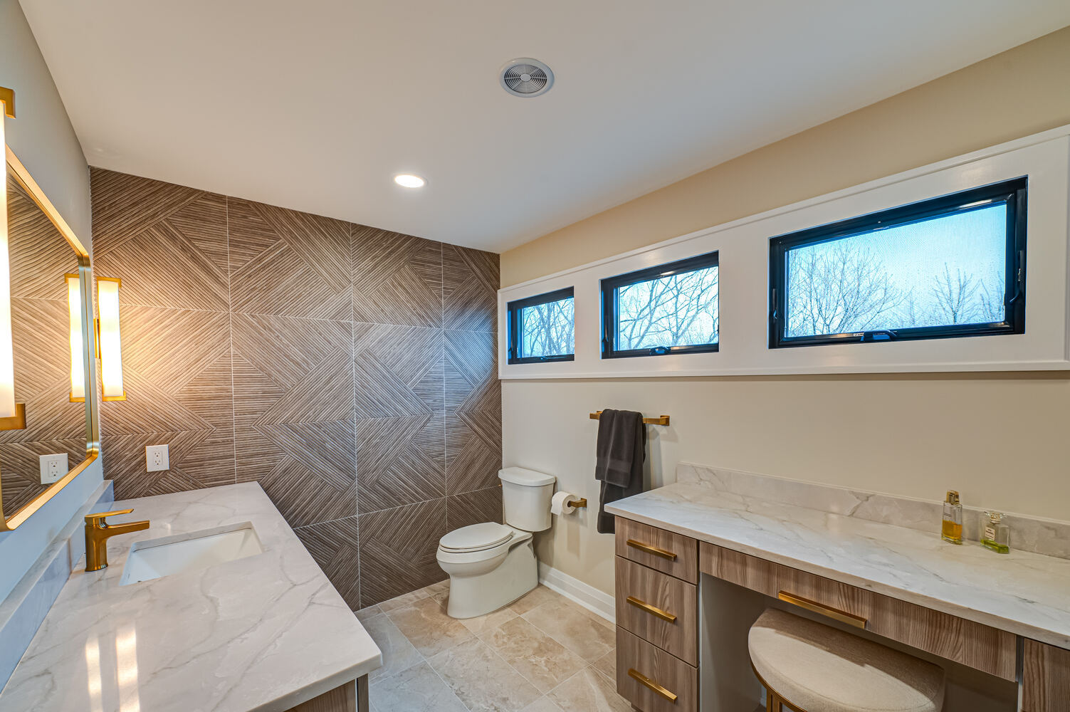 Luxury bathroom with custom tile accent wall and dual vanity in a Miller Place home by Long Island Creative Contracting