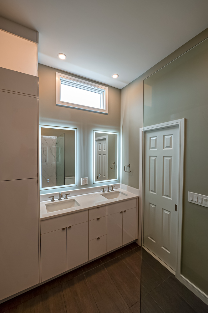 Custom bathroom vanity with LED-lit mirrors in Long Island Creative Contracting home in Mount Sinai, NY