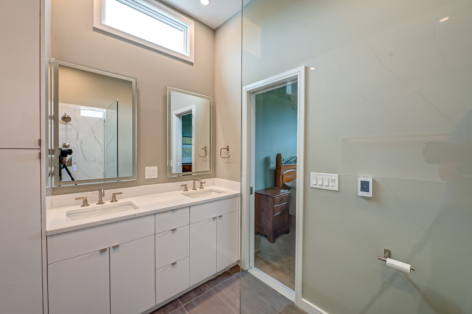 Elegant double vanity with LED mirrors and recessed window in Long Island Creative Contracting home