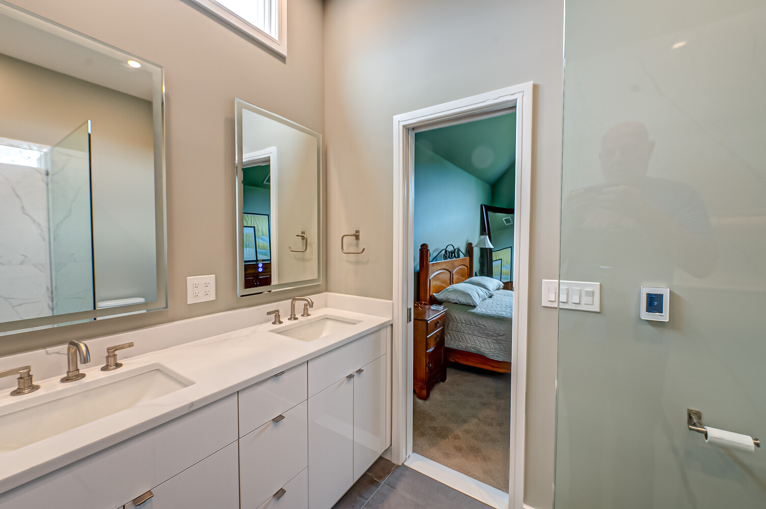 Open layout master bathroom with double vanity and bedroom access in Suffolk County custom home
