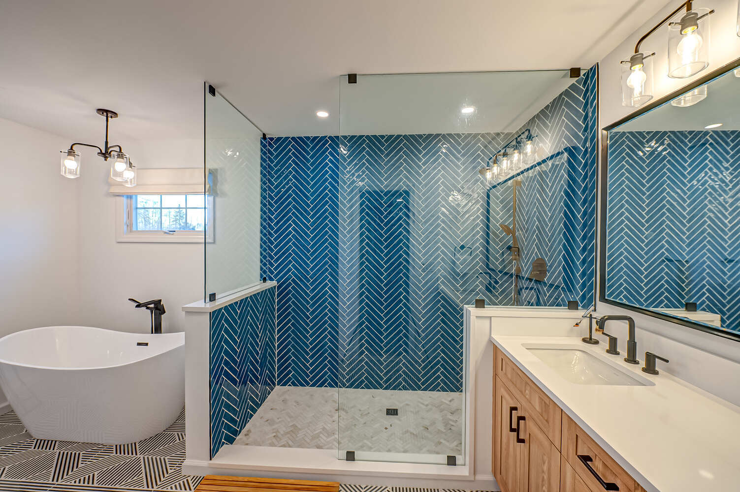 Contemporary bath with striking blue tile and clean finishes by Long Island Creative Contracting, Inc