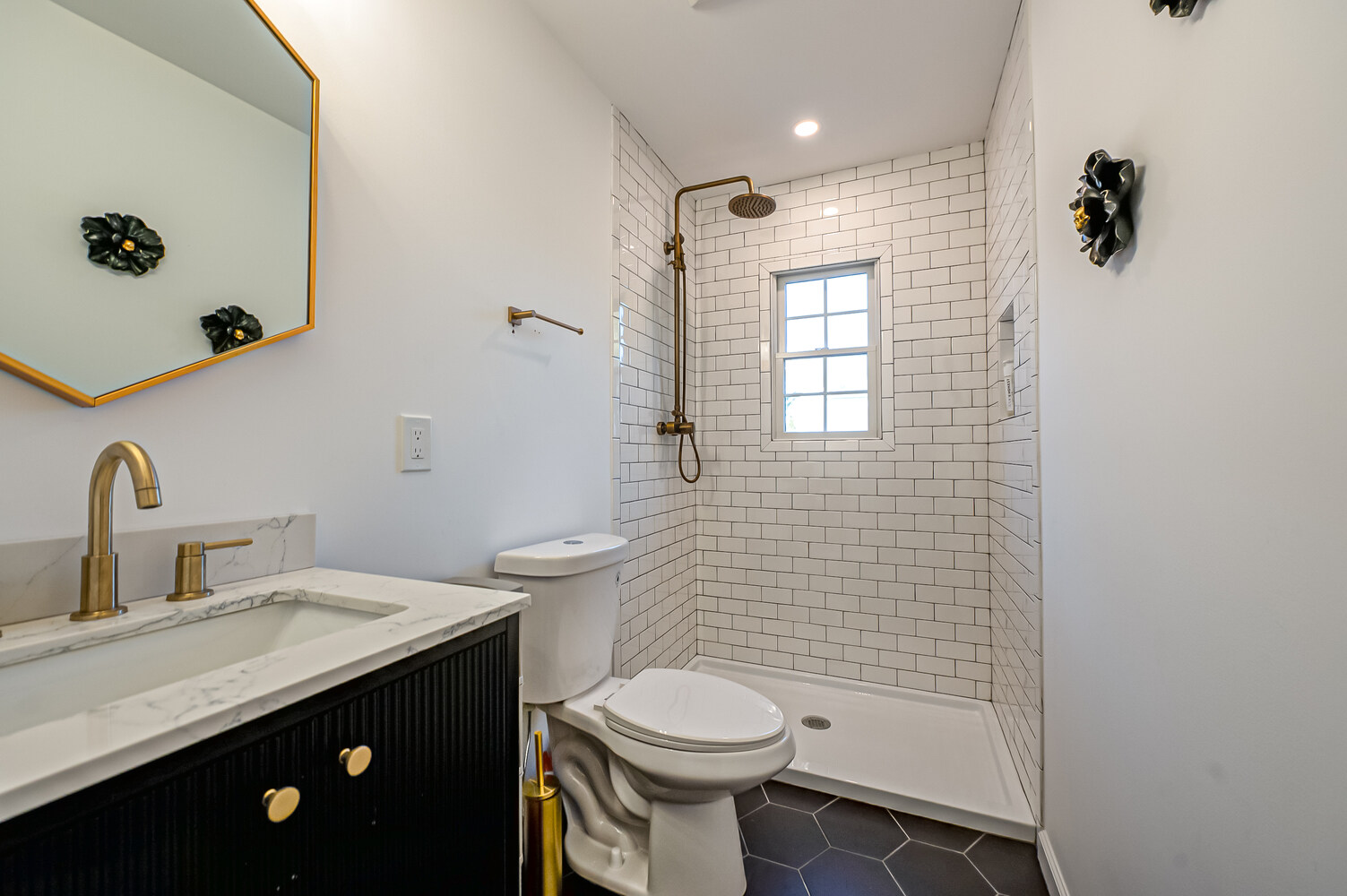 White subway tile bathroom with brass fixtures in Miller Place, NY custom home by Long Island Creative Contracting, Inc