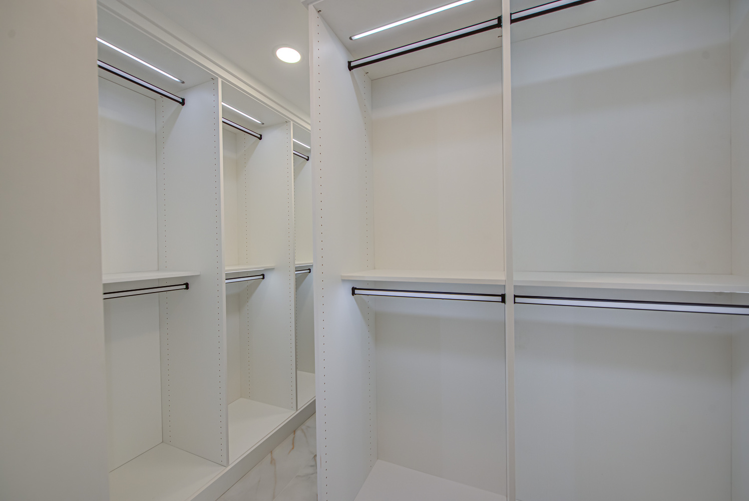 Clean modern closet design with spacious vertical storage by Long Island Creative Contracting, Inc. in Old Field, NY