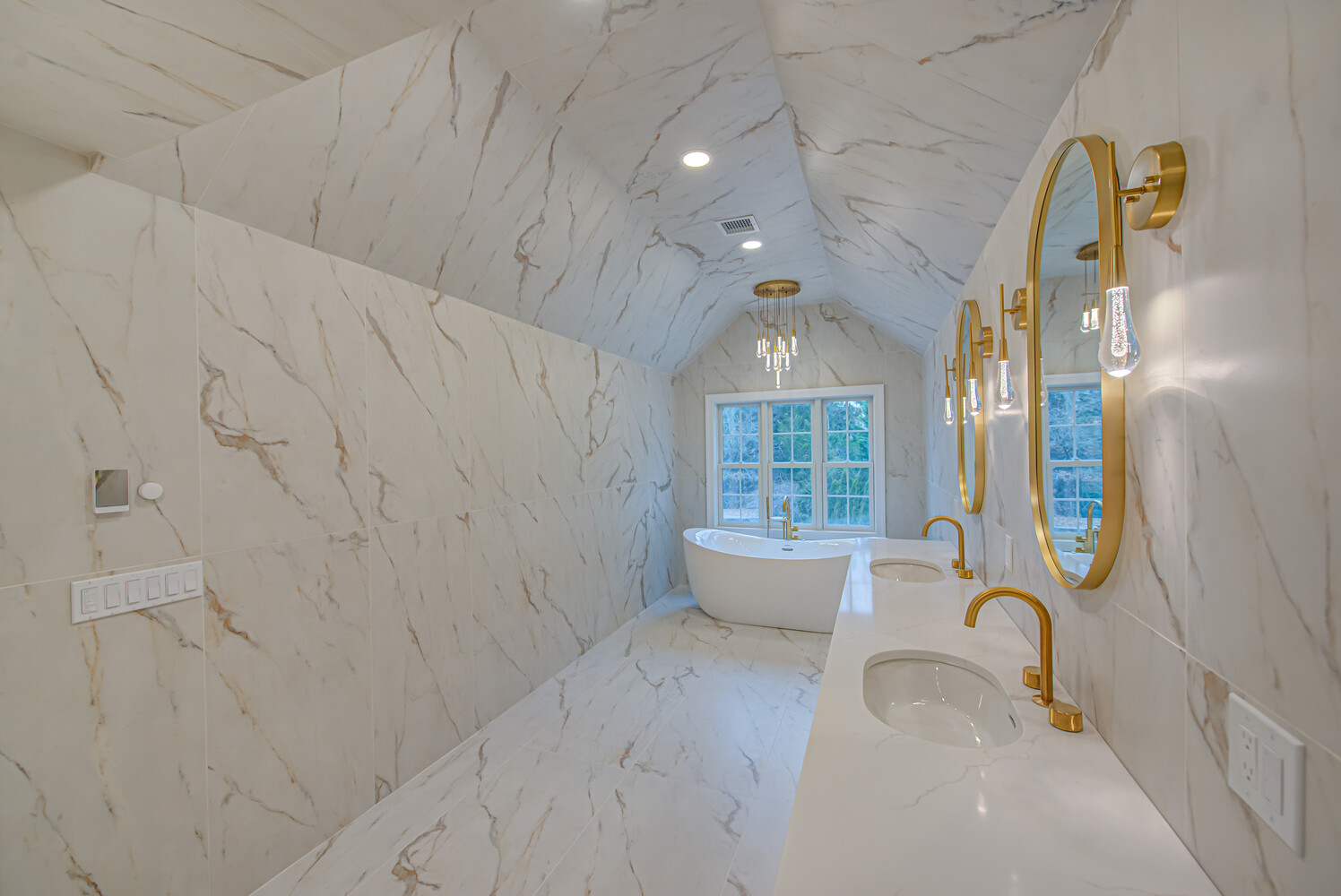Gold-accented bathroom vanity with dual sinks in custom home by Long Island Creative Contracting, Inc. in Stony Brook, NY
