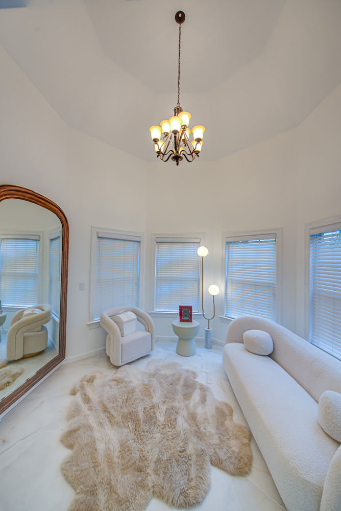 Sitting room with chandelier and fur rug in a Long Island Creative Contracting, Inc. custom home build in Stony Brook, NY