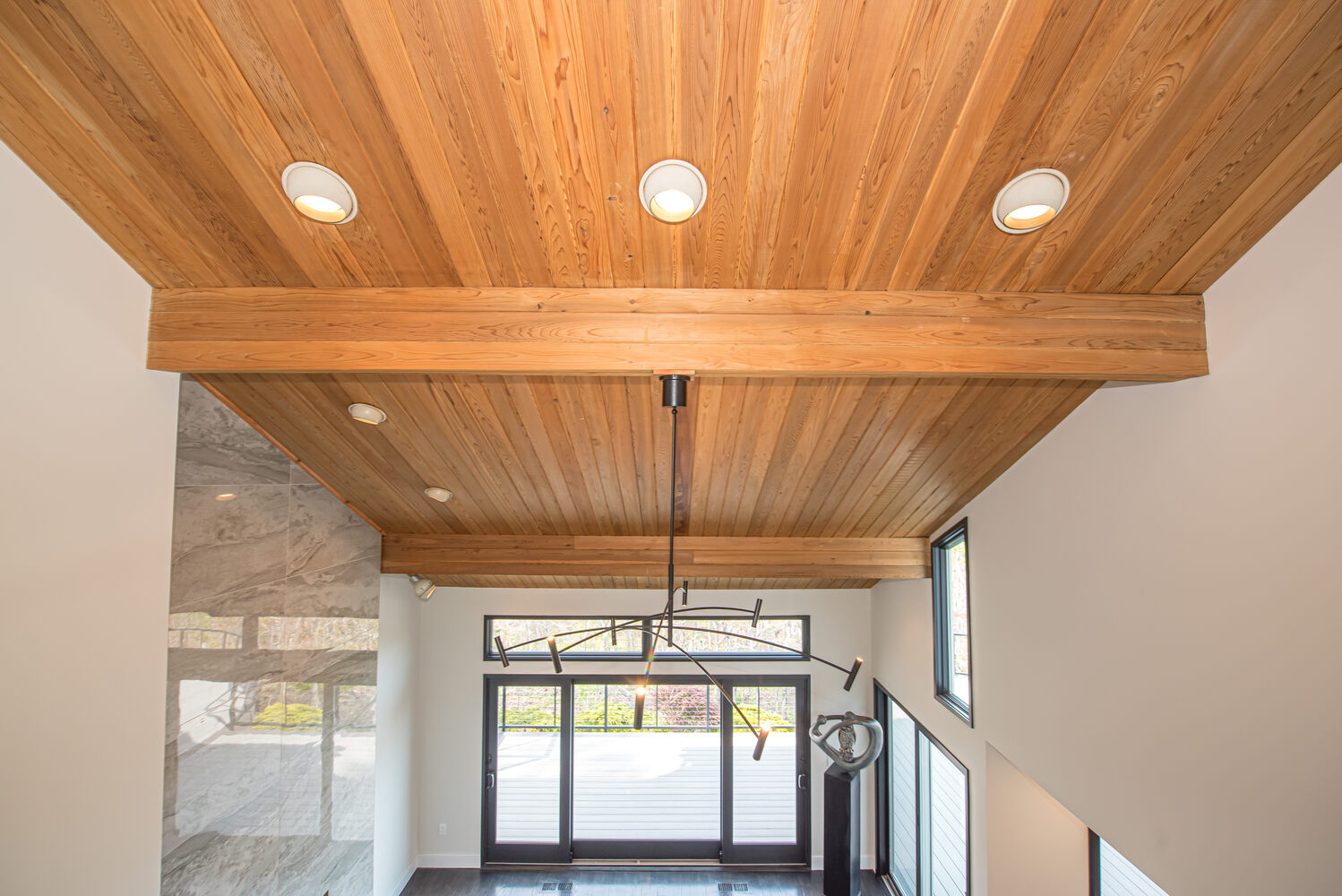 Custom ceiling beams and light fixture in an Old Field NY custom home by Long Island Creative Contracting, Inc