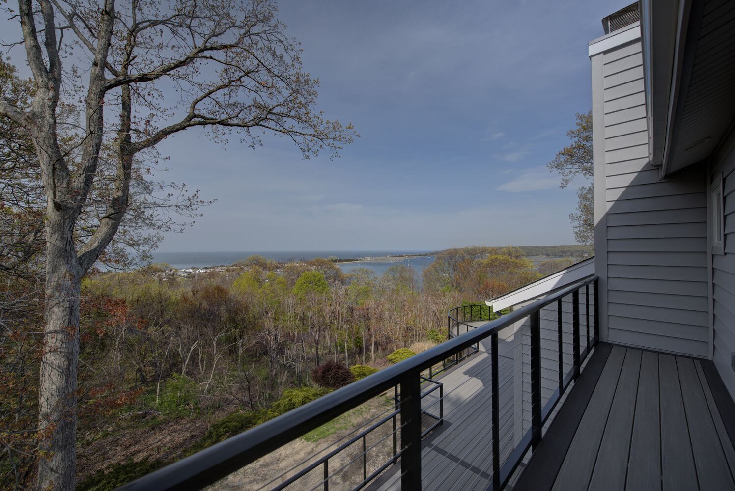 Expansive custom home deck with ocean views in Miller Place, NY by Long Island Creative Contracting, Inc