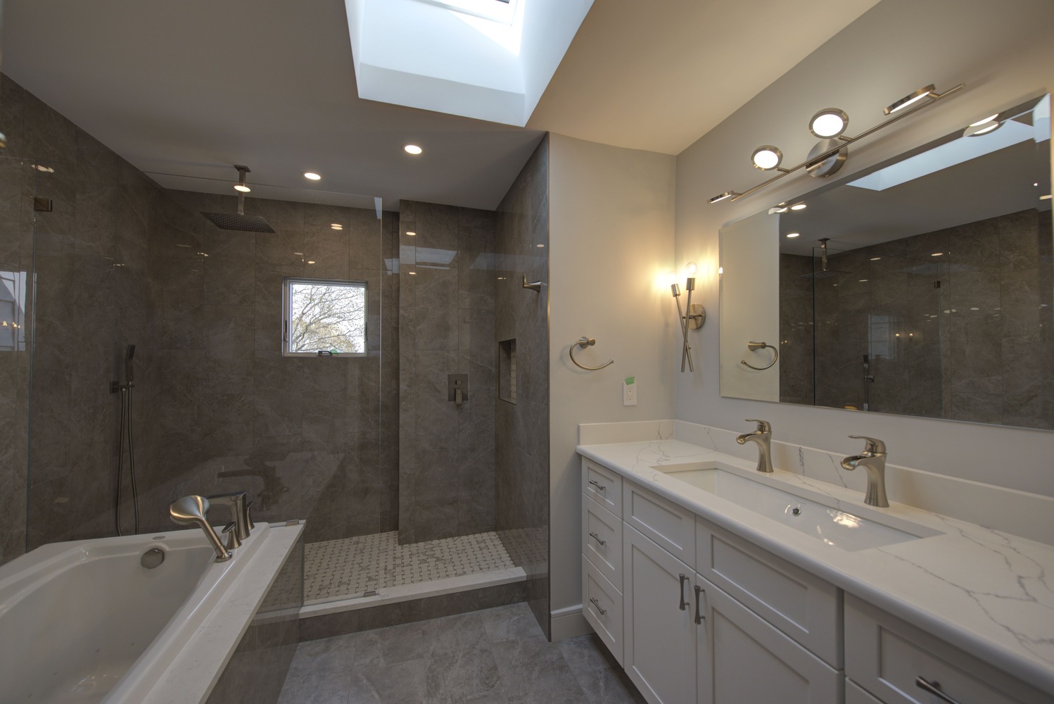 Modern custom home bathroom featuring walk-in glass shower and soaking tub in Setauket, NY