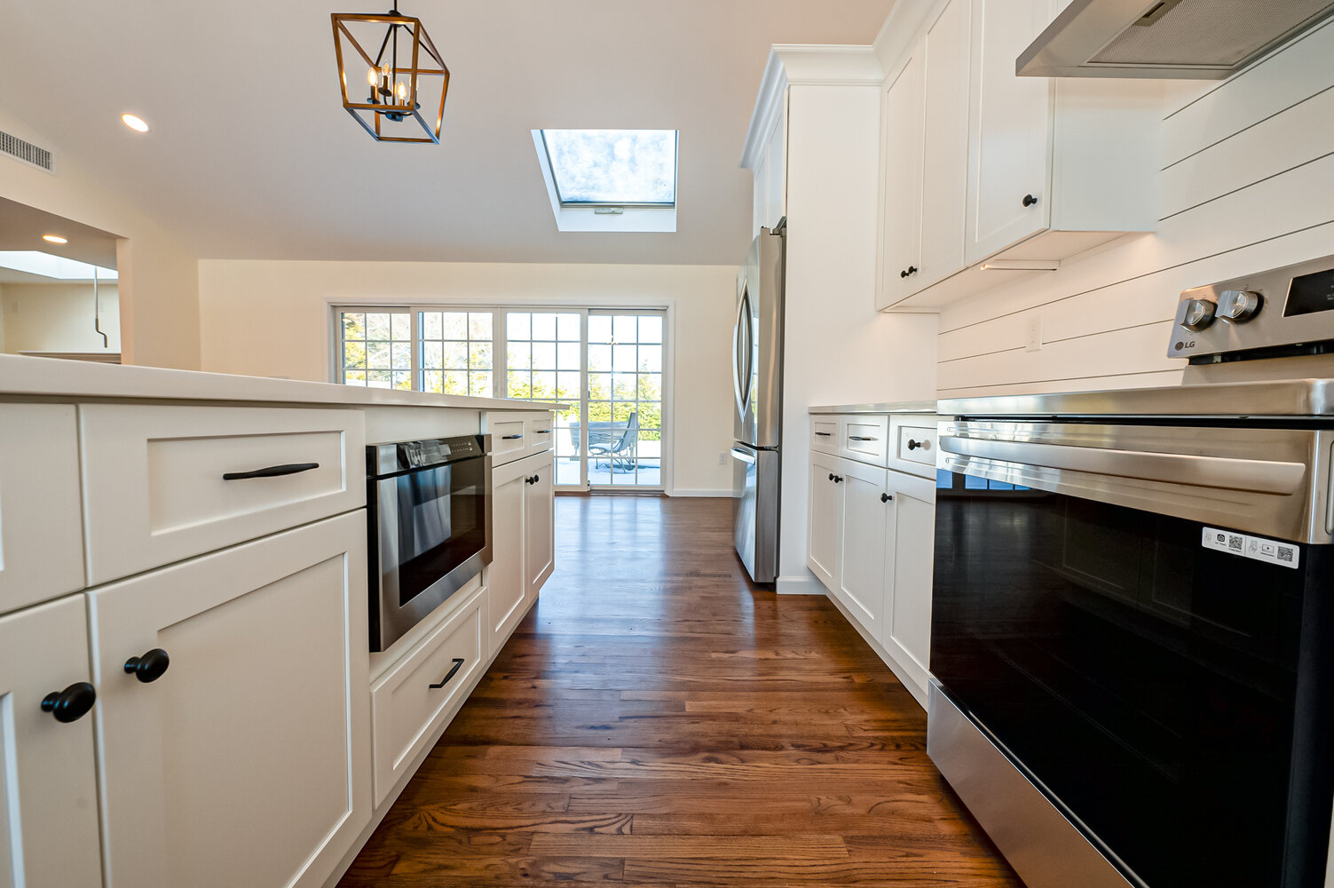 Custom kitchen by Long Island Creative Contracting, Inc. featuring clean lines and stainless appliances in Northport, NY