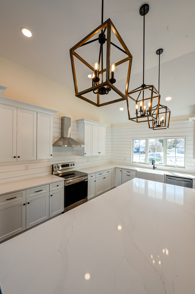 Custom kitchen with shaker cabinets and pendant lighting by Long Island Creative Contracting, Inc. in Stony Brook, NY