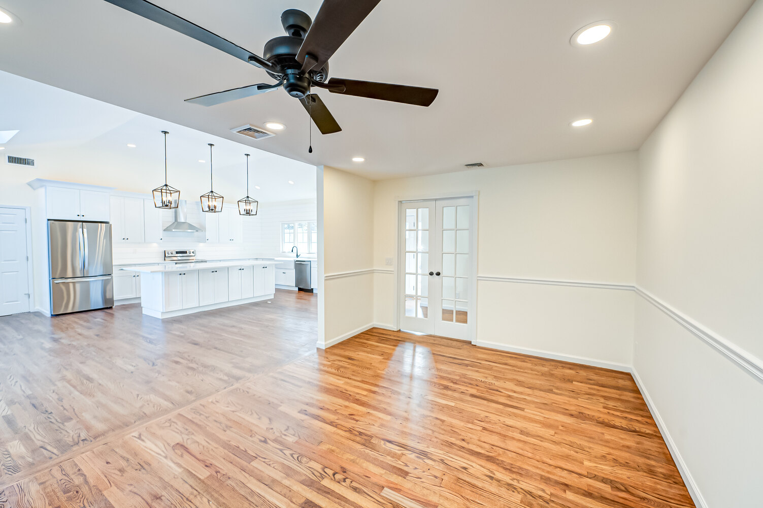 Seamless transition from dining to kitchen space in a Northport, NY custom home