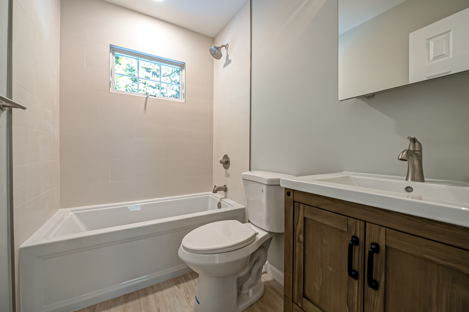 Sleek bathroom design featuring bathtub and single vanity by Long Island Creative Contracting, Inc. in Suffolk County, NY