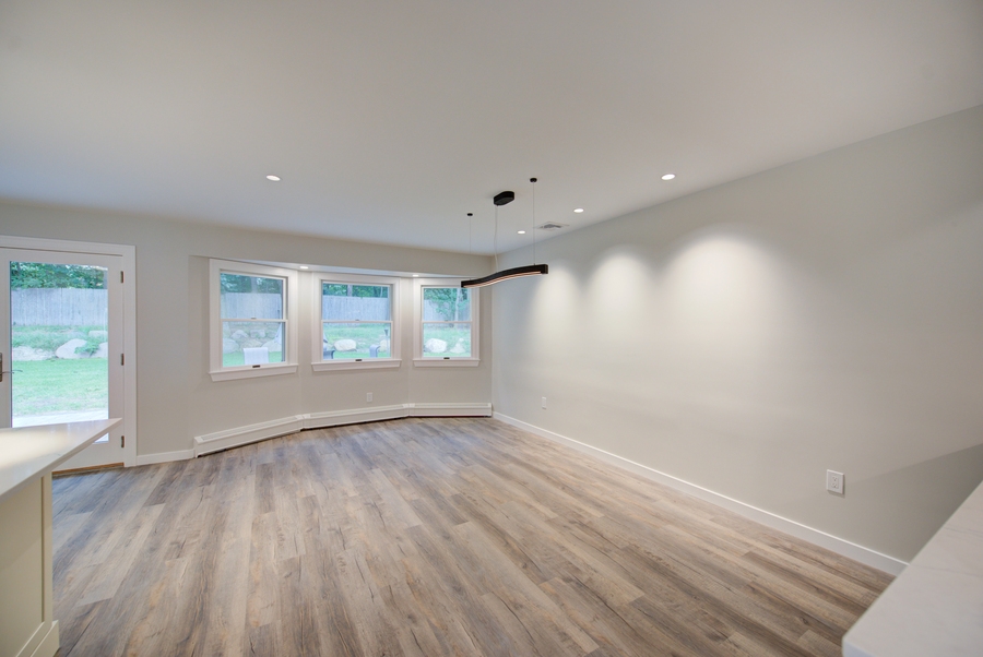 Bright and open dining room with modern lighting in a Suffolk County custom home by Long Island Creative Contracting, Inc