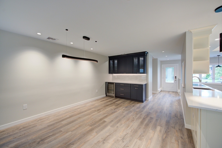 Dining area with built-in dark cabinetry in a Suffolk County custom home by Long Island Creative Contracting, Inc