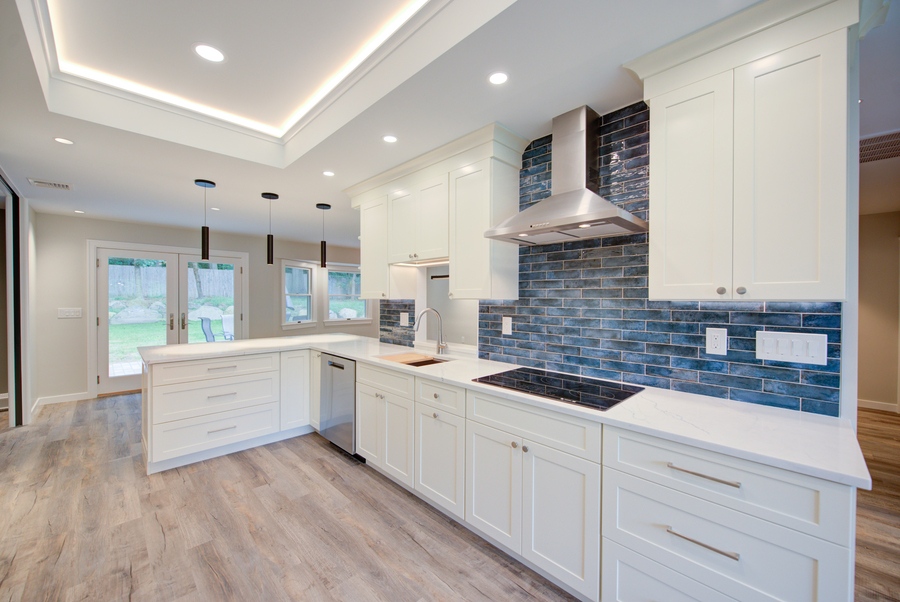 Full kitchen remodel with peninsula and blue tile accent wall by Long Island Creative Contracting, Inc. in Suffolk County, NY