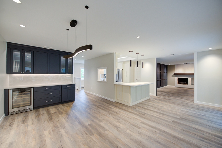 Kitchen renovation with modern lighting and wood floors in a Suffolk County home by Long Island Creative Contracting, Inc