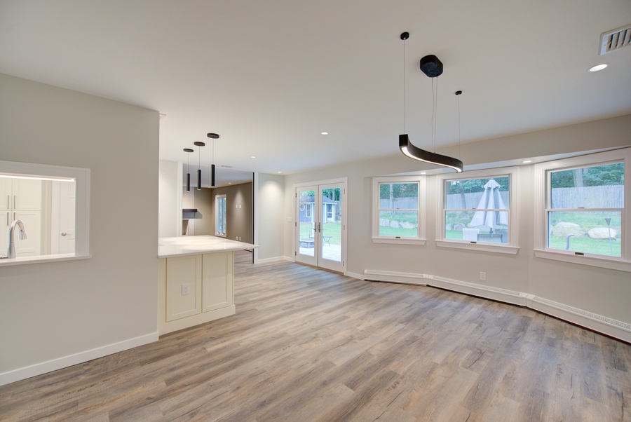 Light-filled dining area overlooking backyard in a Suffolk County custom home by Long Island Creative Contracting, Inc