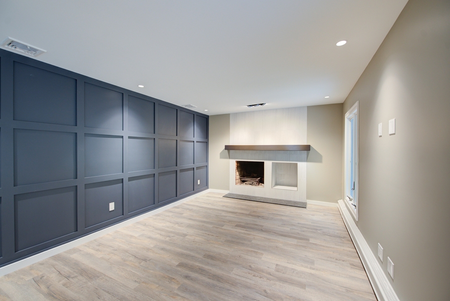Modern fireplace with geometric panel accent wall in a Remsenberg, NY living room remodel
