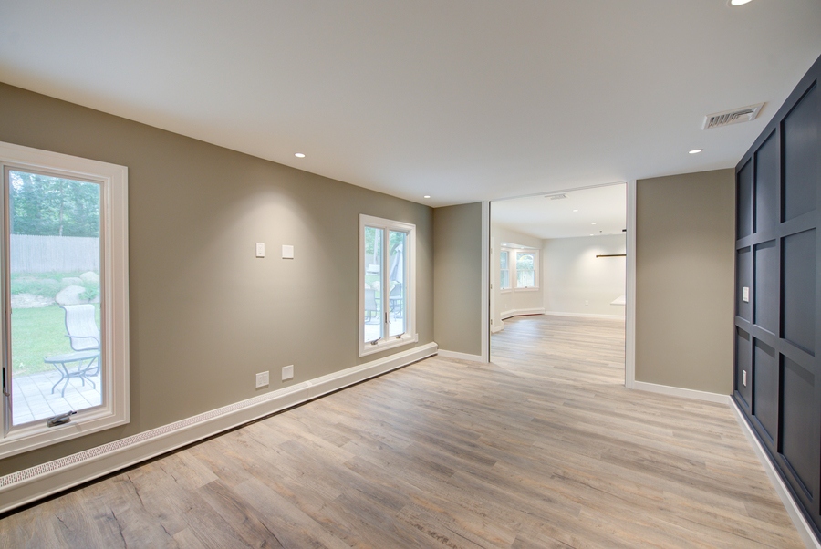 Open-concept transitional space with wide plank flooring in a Suffolk County custom home