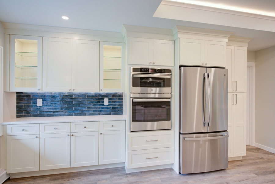 White cabinetry kitchen with stainless appliances in a custom home by Long Island Creative Contracting, Inc. in Suffolk County, NY