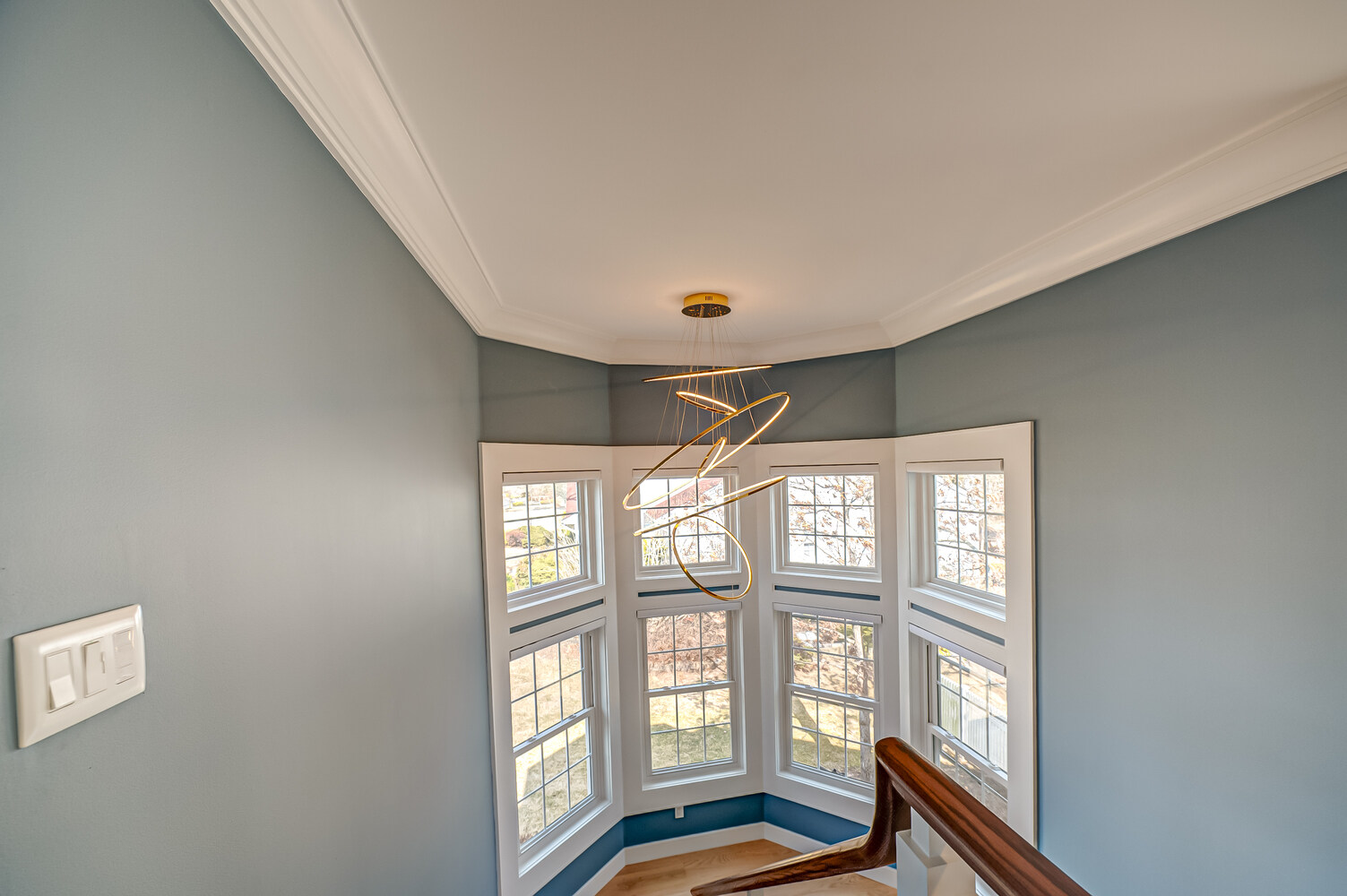 Angled view of staircase and windows in East Setauket, NY custom home build by Long Island Creative Contracting, Inc