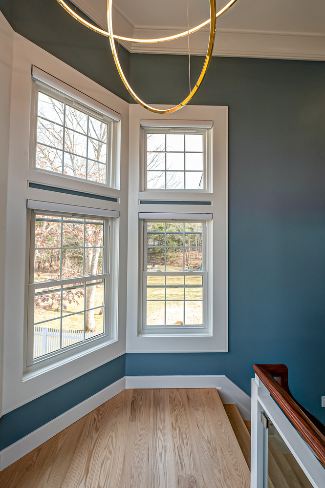 Custom window arrangement with gold chandelier in Northport, NY home by Long Island Creative Contracting, Inc