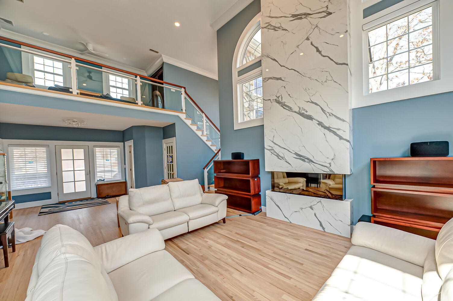 Transitional stairwell with modern finishes in a Woodbury, NY home by Long Island Creative Contracting, Inc