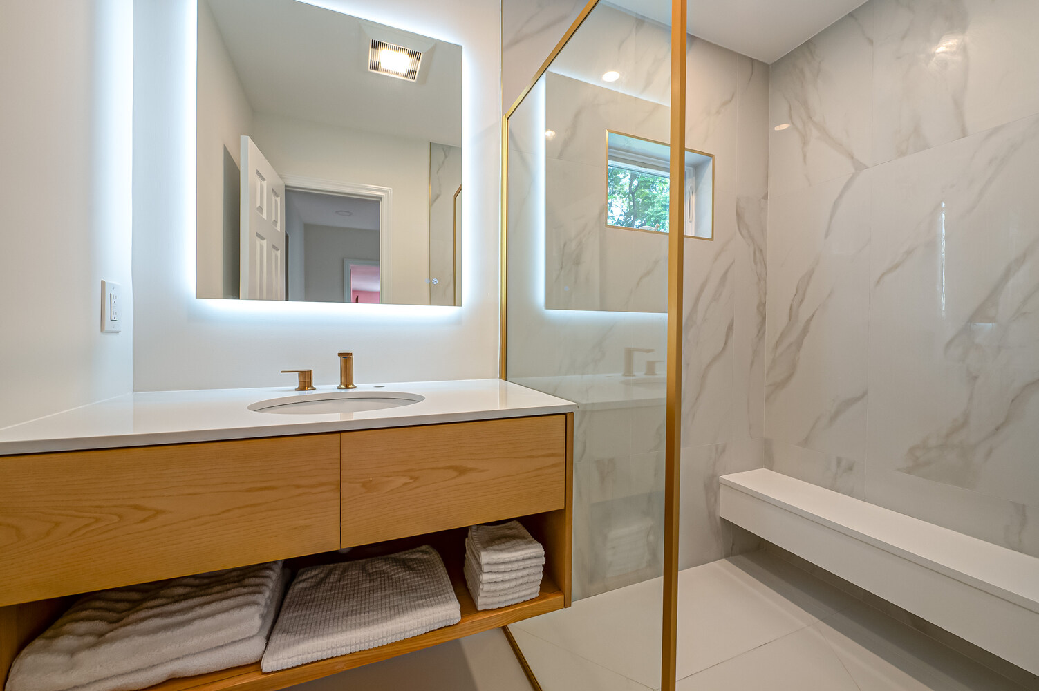 Modern bathroom vanity and illuminated mirror in a custom-built home by Long Island Creative Contracting in Stony Brook, NY Modern bathroom vanity and illuminated mirror in a custom-built home by Long Island Creative Contracting in Stony Brook, NY