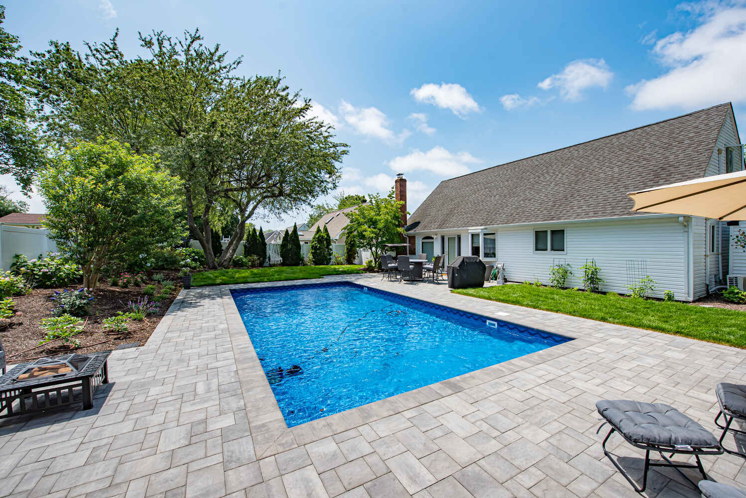 Backyard pool installation at a custom home in Miller Place, NY by Long Island Creative Contracting, Inc.