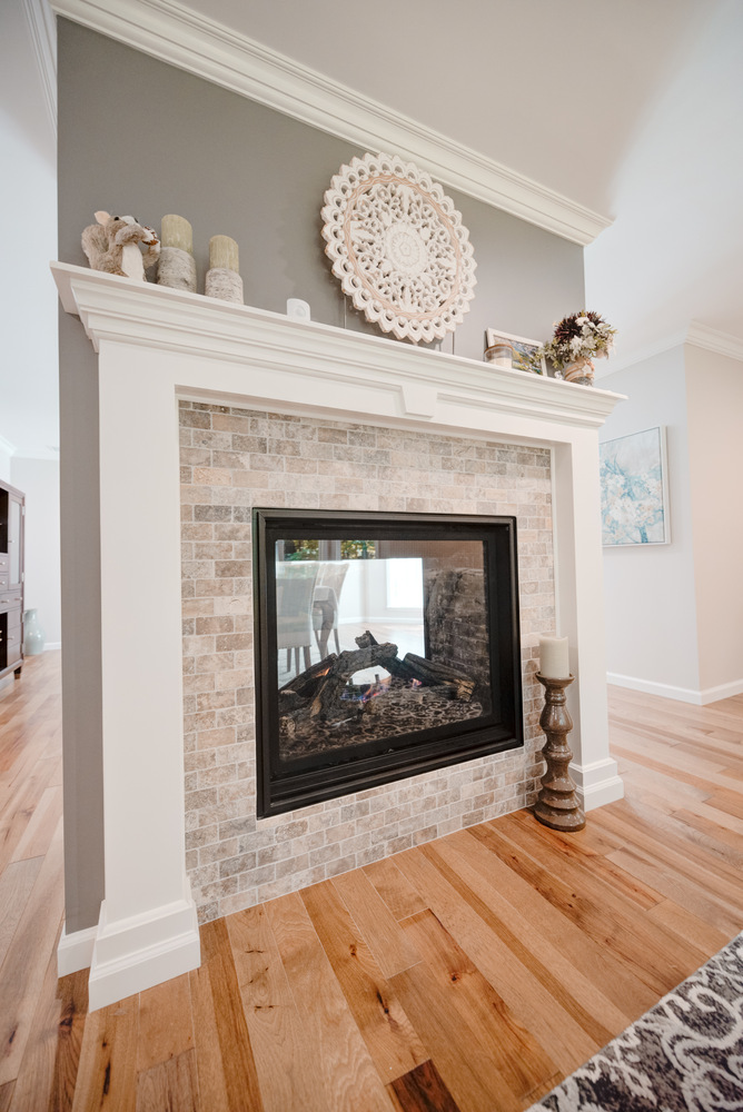 Close-up of dual-sided fireplace in a custom home build by Long Island Creative Contracting, Inc. in Miller Place, NY