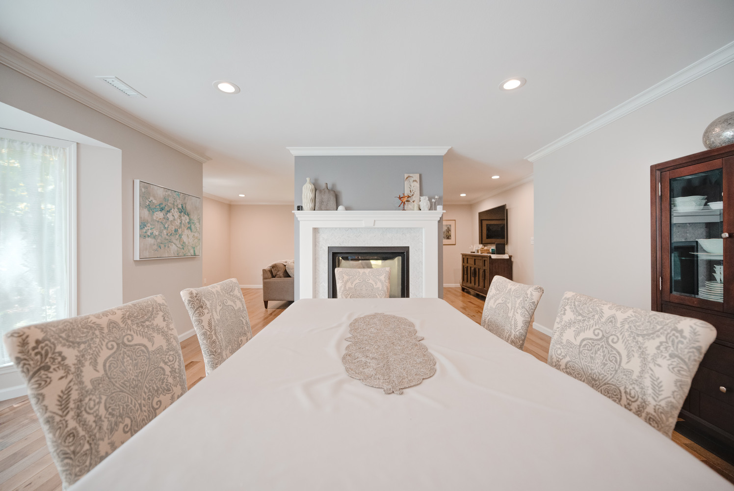 Dining room with fireplace centerpiece in a custom Suffolk County home by Long Island Creative Contracting, Inc