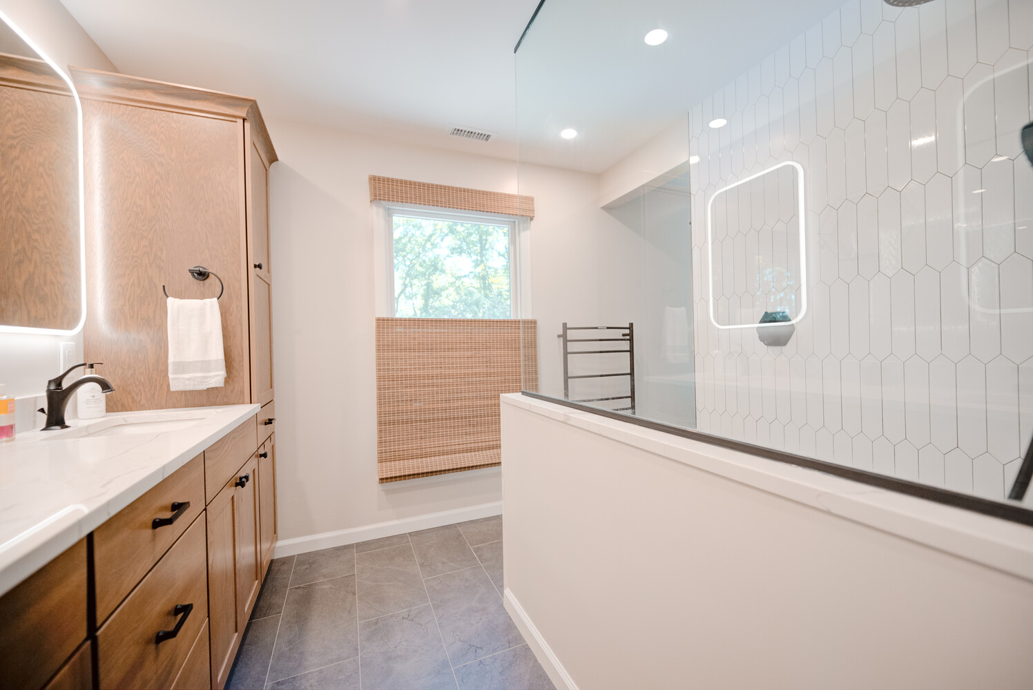 Elegant custom bathroom with glass-enclosed shower and modern tile design in Miller Place, NY