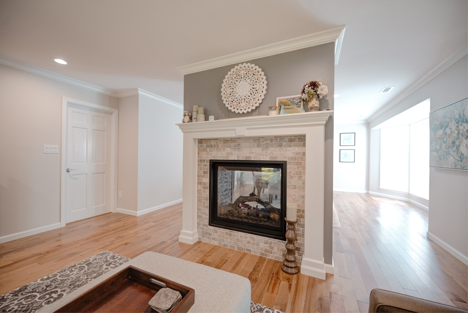 Elegant custom fireplace with stone tile surround and mantel in a Northport, NY living room