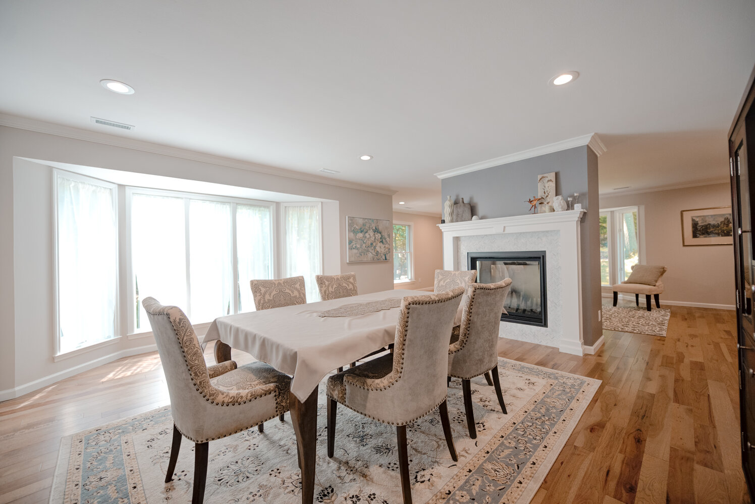 Elegant dining area with large windows and modern decor in a Suffolk County home