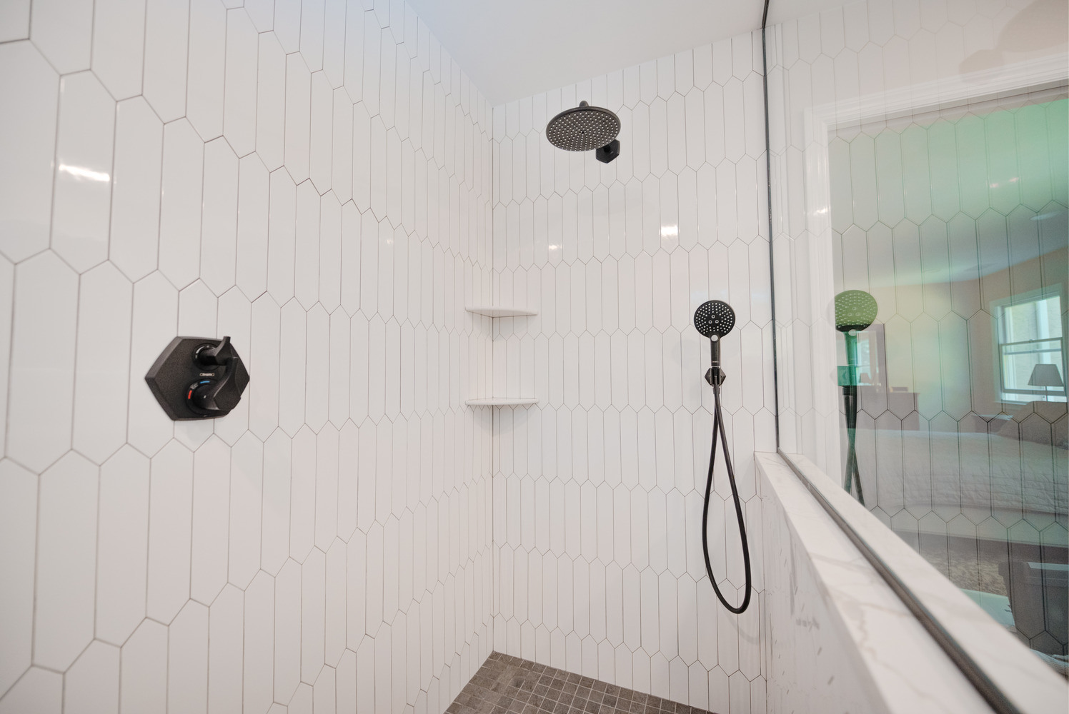 Elegant walk-in shower with matte black hardware and modern tile in Suffolk County custom build