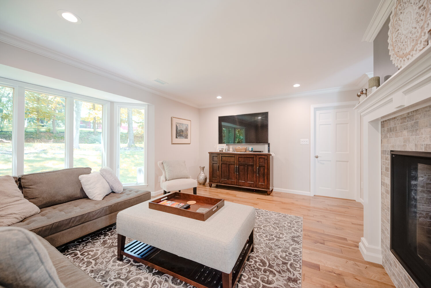 Spacious dining room with elegant furnishings and hardwood floors in a Stony Brook custom home by Long Island Creative Contracting, Inc