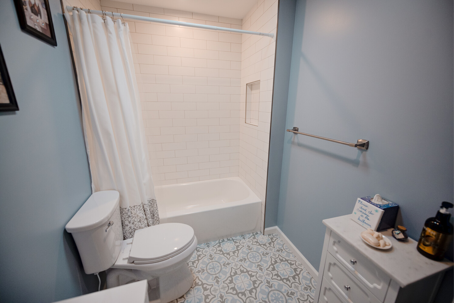 Subway-tiled shower with light blue walls in a Miller Place custom home by Long Island Creative Contracting