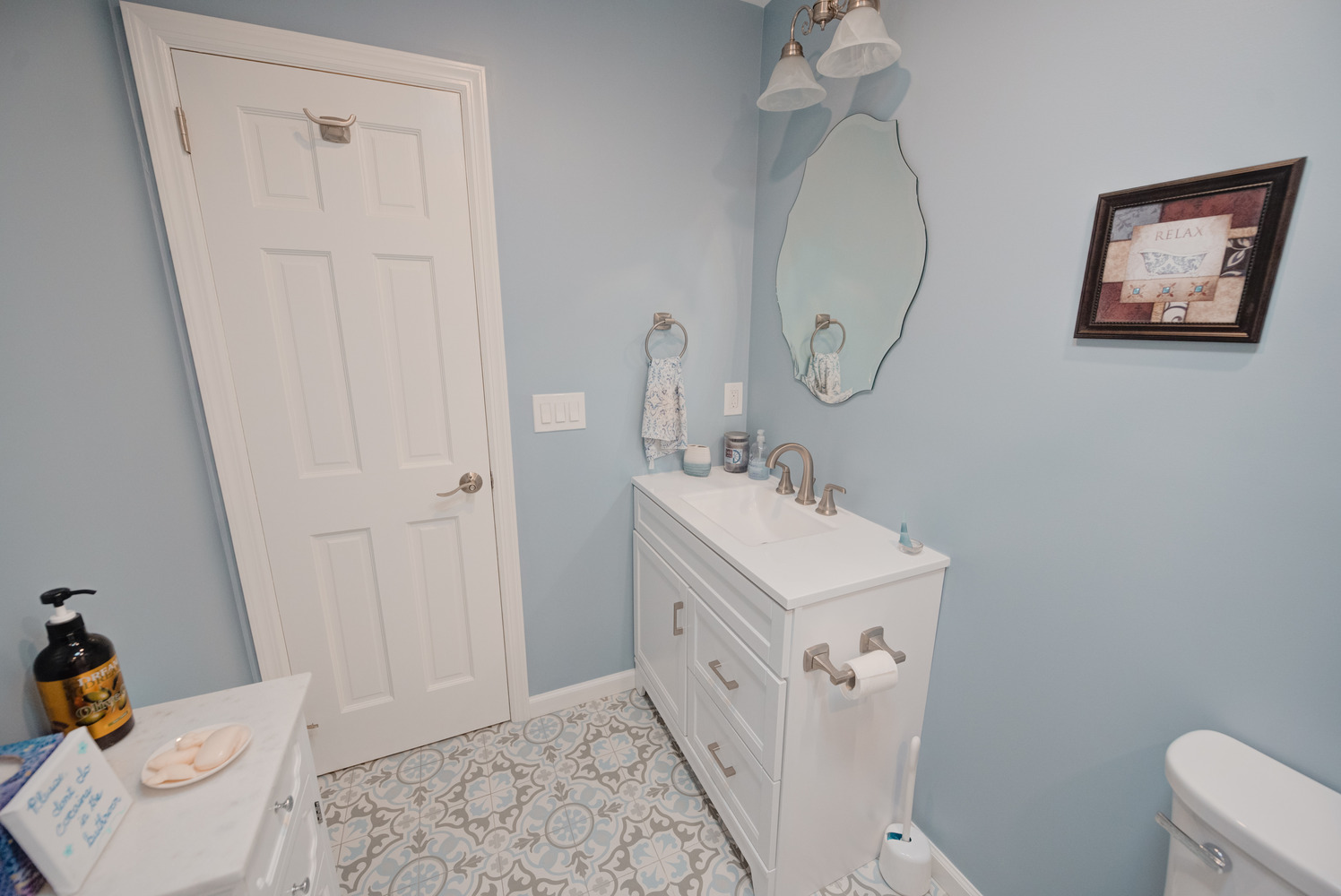 White vanity with double drawers and silver accents in a Miller Place bathroom by Long Island Creative Contracting