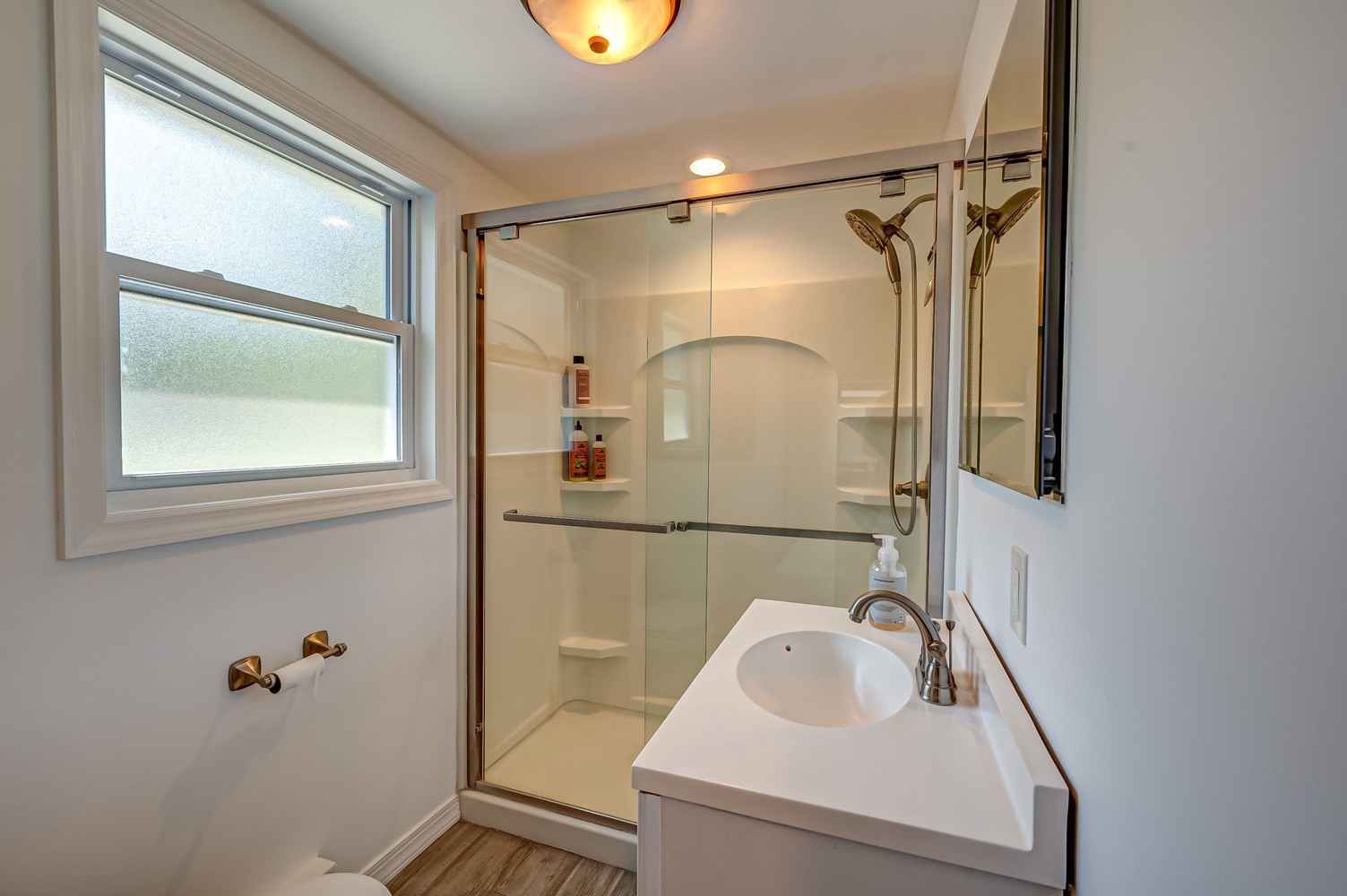 Guest bathroom with glass shower and single vanity in a Suffolk County custom home by Long Island Creative Contracting