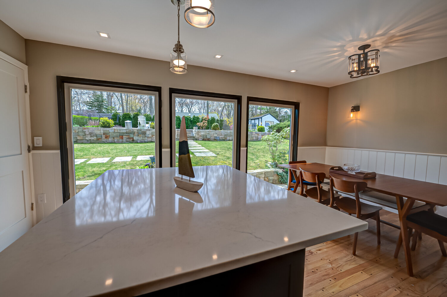 Bright kitchen remodel with center island and outdoor access in Stony Brook, NY by Long Island Creative Contracting, Inc