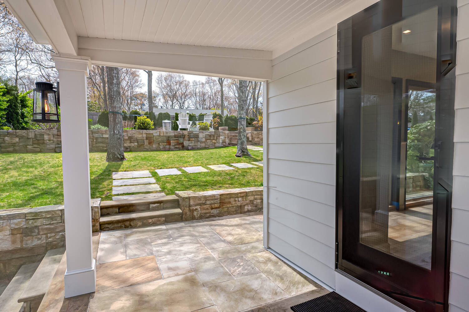 Custom porch entry overlooking terraced backyard in Suffolk County, NY