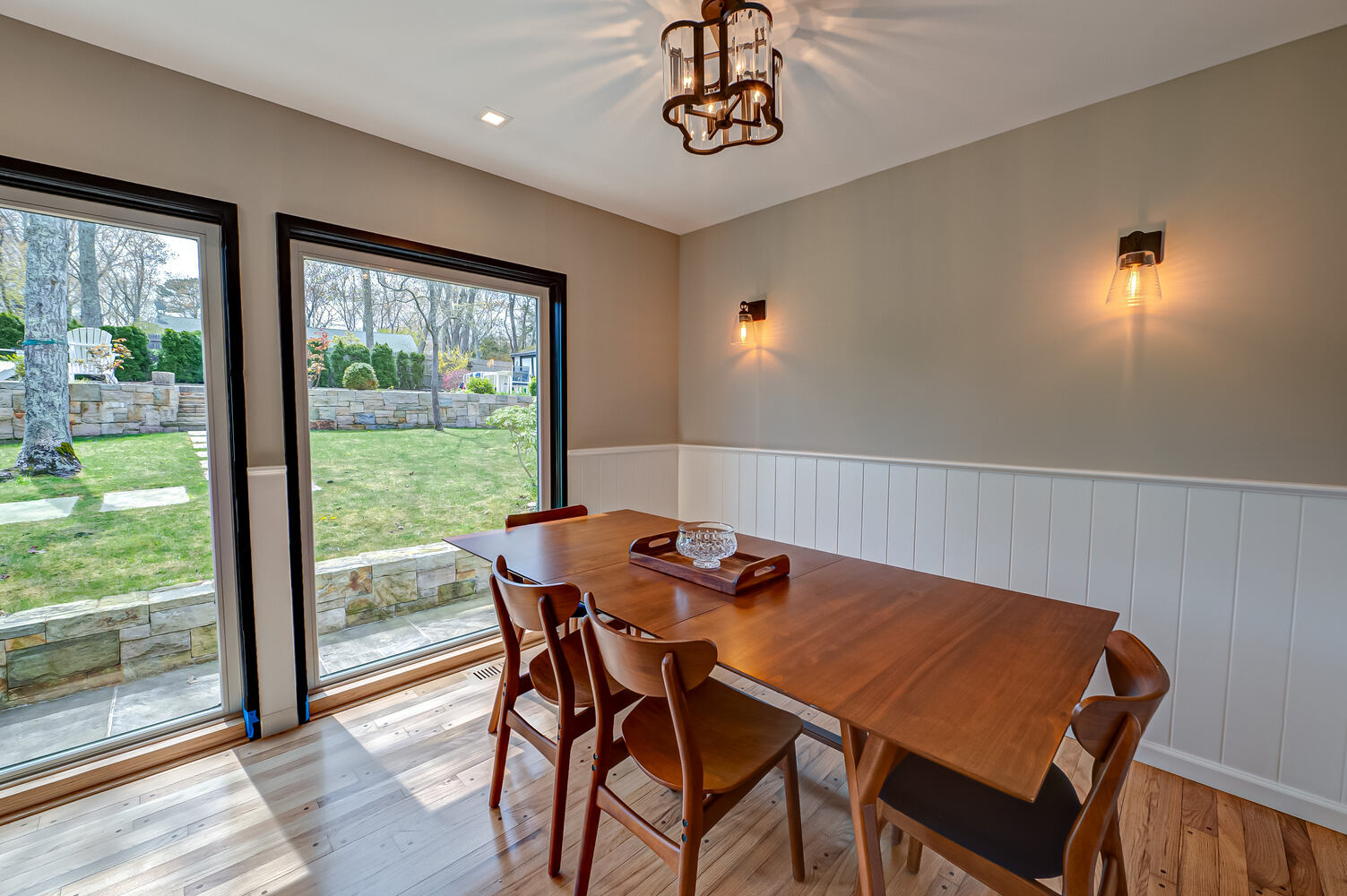 Dining room remodel with large garden-facing windows in Port Jefferson, NY by Long Island Creative Contracting, Inc