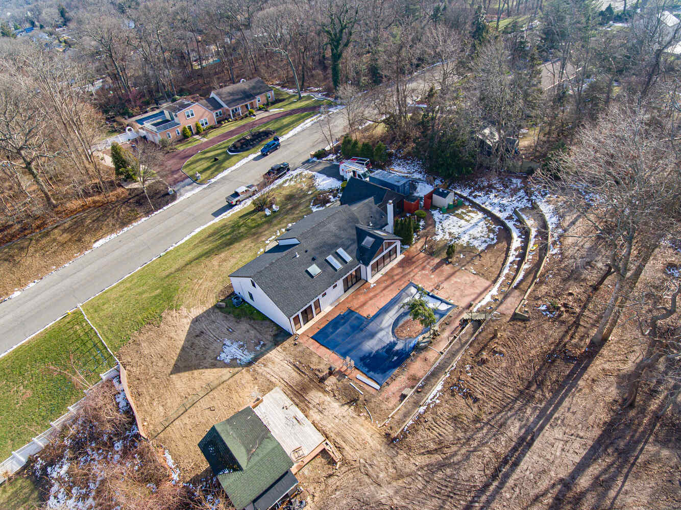 Drone photo capturing landscape integration and architecture of Miller Place custom home