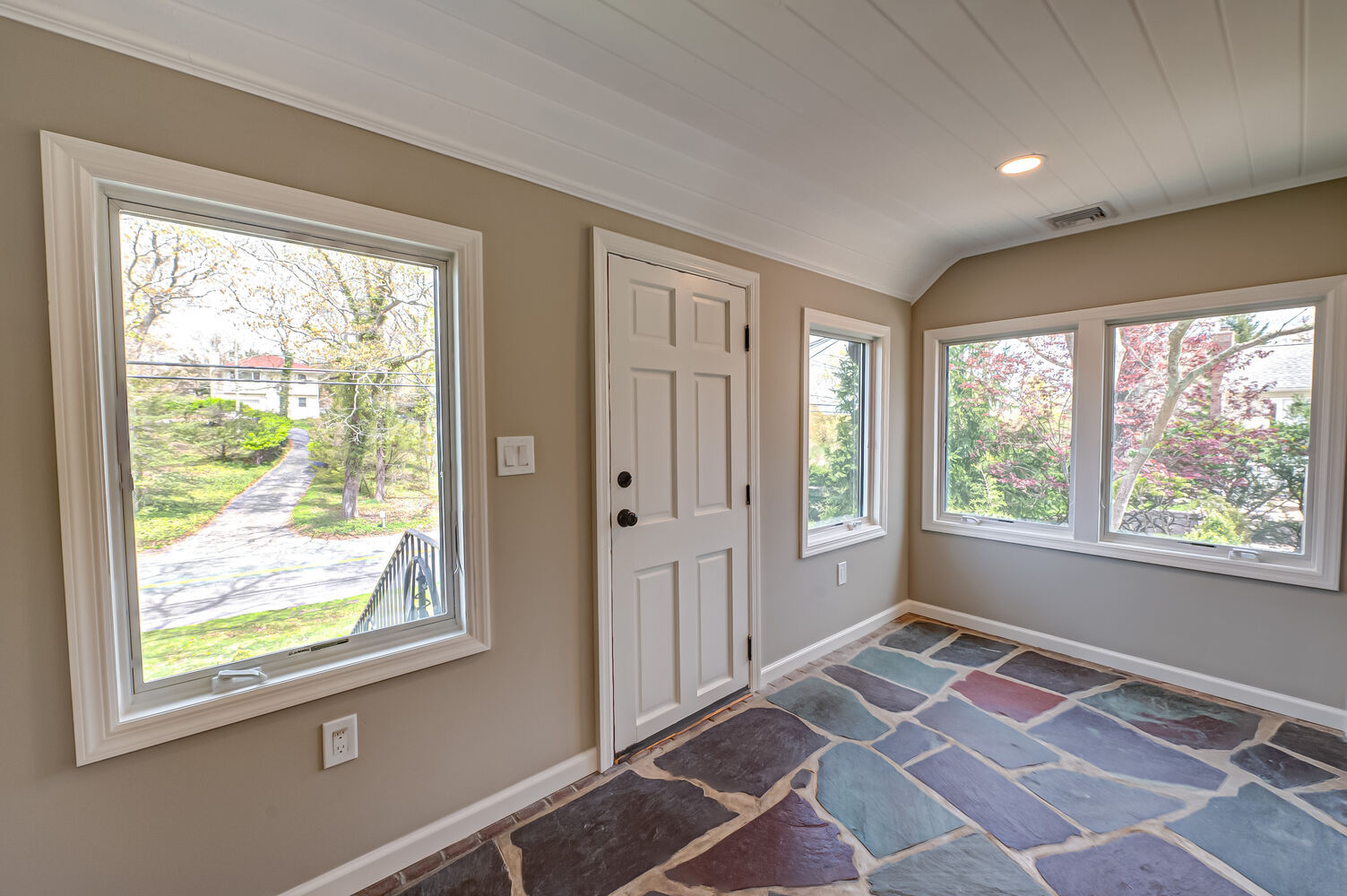 Entryway with abundant natural light and white paneled ceiling in a Miller Place custom home build