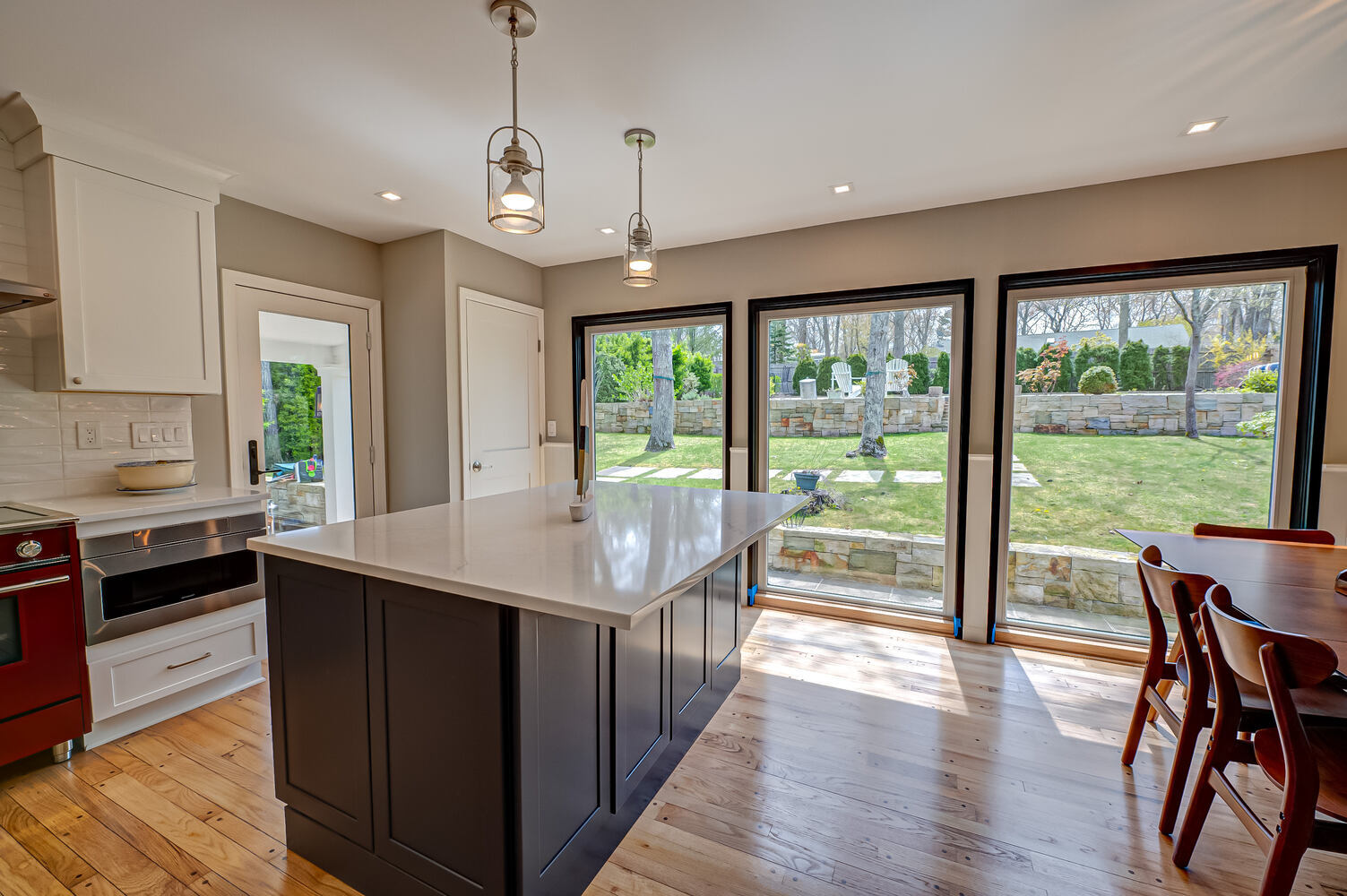 Natural light-filled kitchen renovation with black-framed windows in Miller Place, NY by Long Island Creative Contracting, Inc