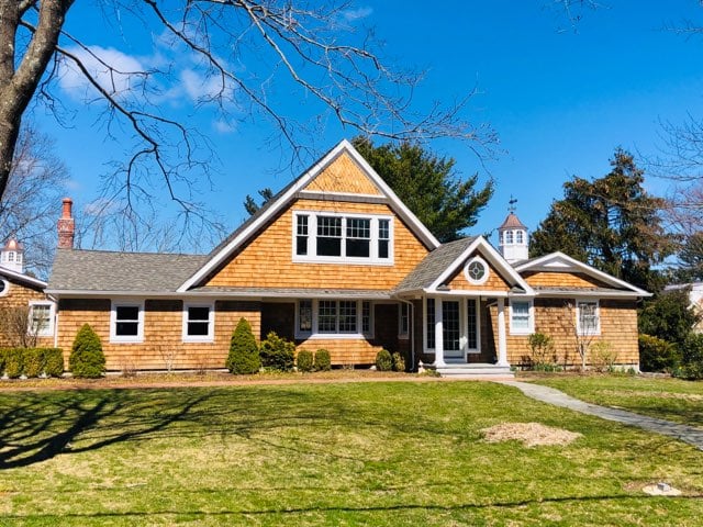 Traditional home cedar shakes with new pitched roof and windows