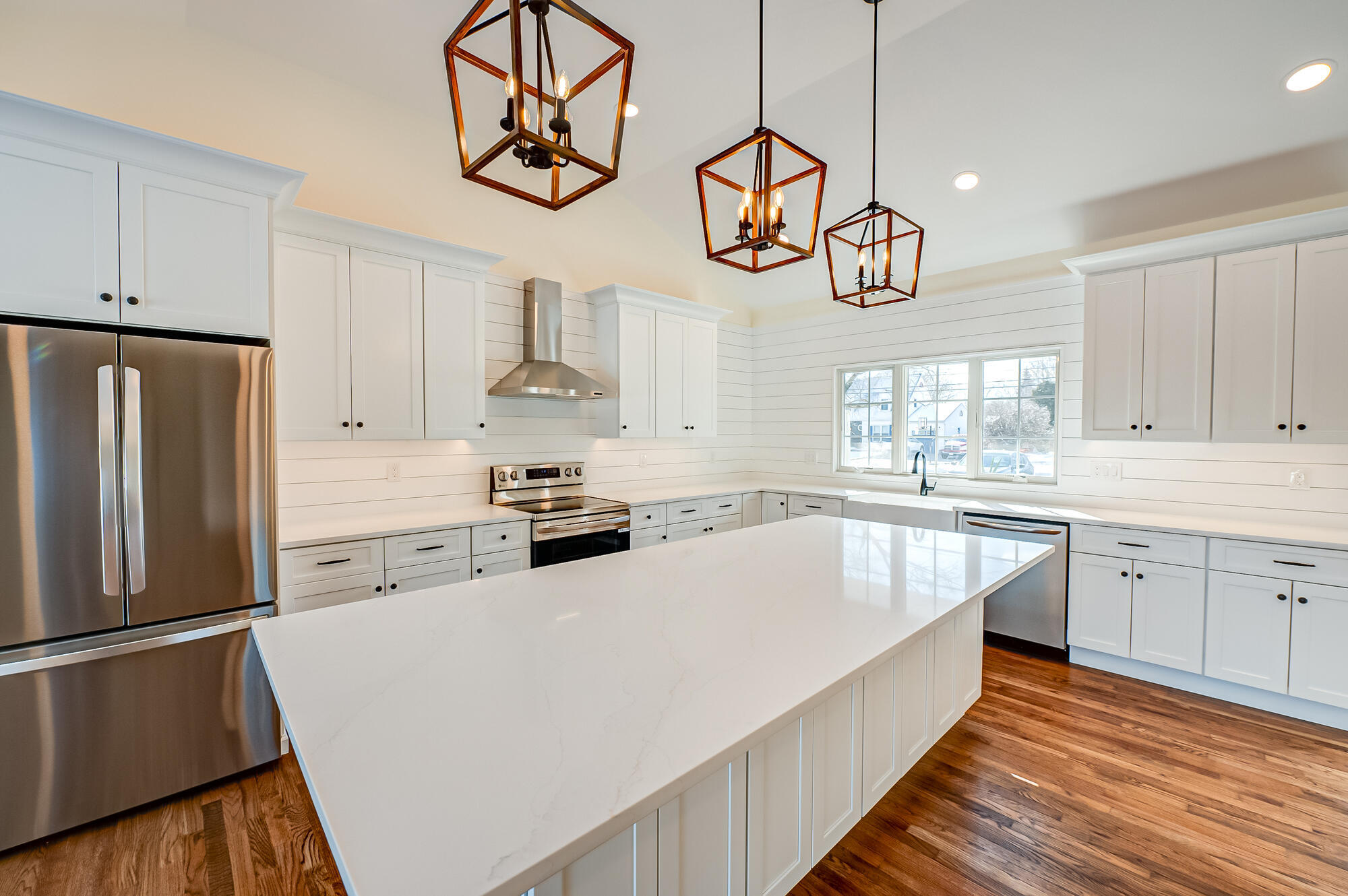 Kitchen island with waterfall countertop in a Huntington, NY custom home by Long Island Creative Contracting