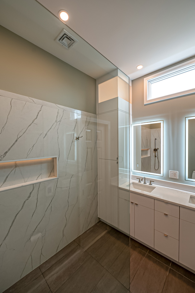 Contemporary bathroom with double sinks and sleek mirror lighting in Port Jefferson home